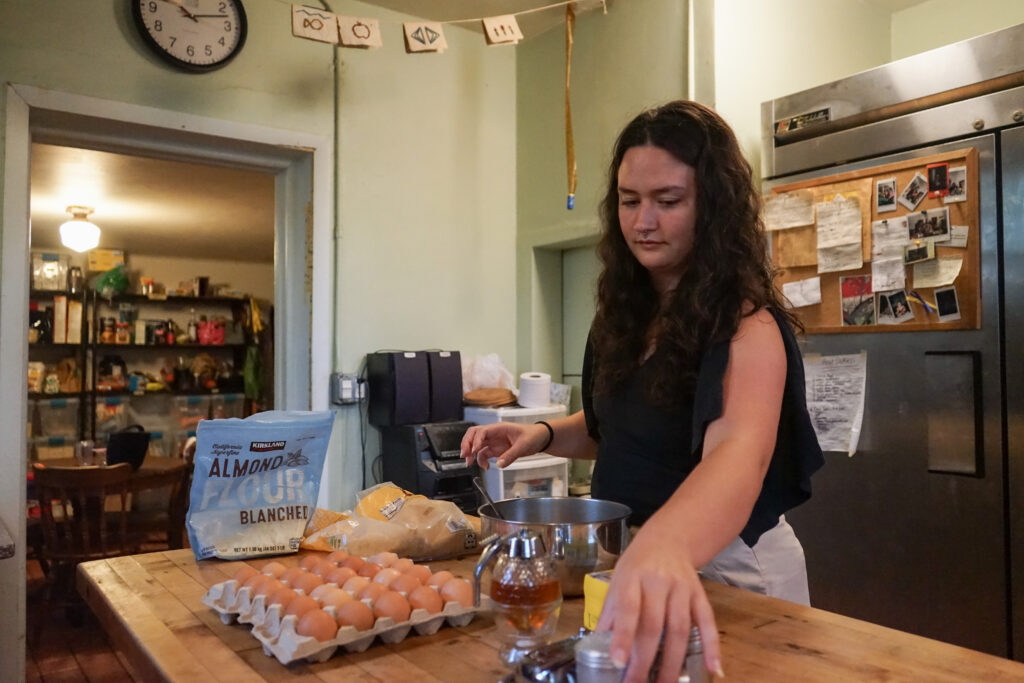 Woman in a kitchen with ingredients in front of her on the counter