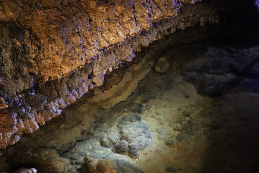 Illuminated pool inside a cave 